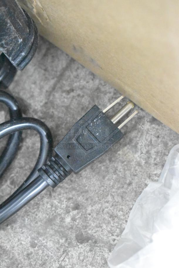 Close-up of a power plug and cable for the Carnival King JETCOF 240M refrigerated beverage dispenser.