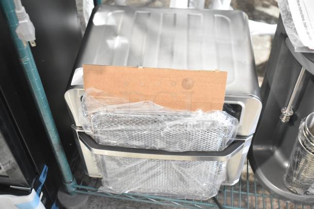 Brand new countertop appliance, 115 Volts, 1 Phase, with visible minor scratches and dents, wrapped with protective packaging.