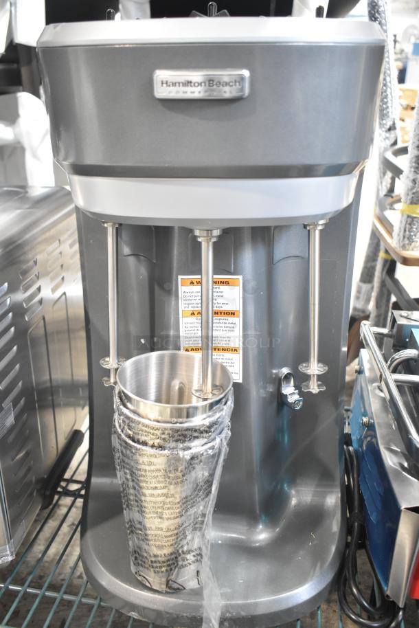 Brand new Hamilton Beach 410HMD400R triple spindle drink mixer, 120V, in protective wrap, shows warning labels.