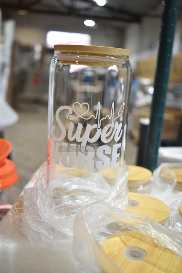 Brand new Super Nurse glass cup with bamboo lid, featuring etched design. Lot of 9, labeled "Scratch and Dent."