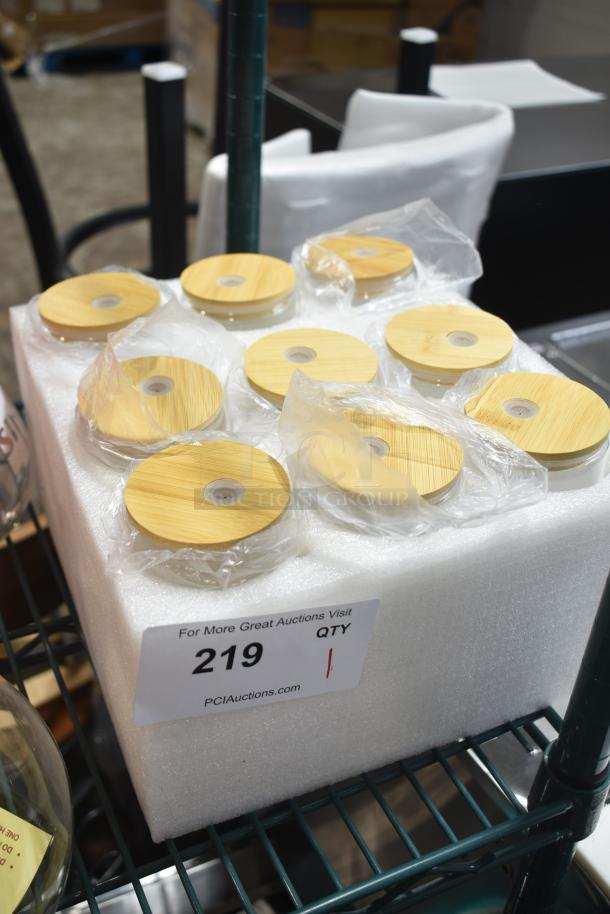 Lot of 9 Super Nurse Cups with bamboo lids, brand new scratch and dent condition, wrapped in plastic, marked "219" for auction.