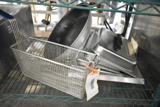 Auction lot of six scratch and dent items, including a Pitco P6072125 basket, skillet, and lids. New condition. Tags visible.