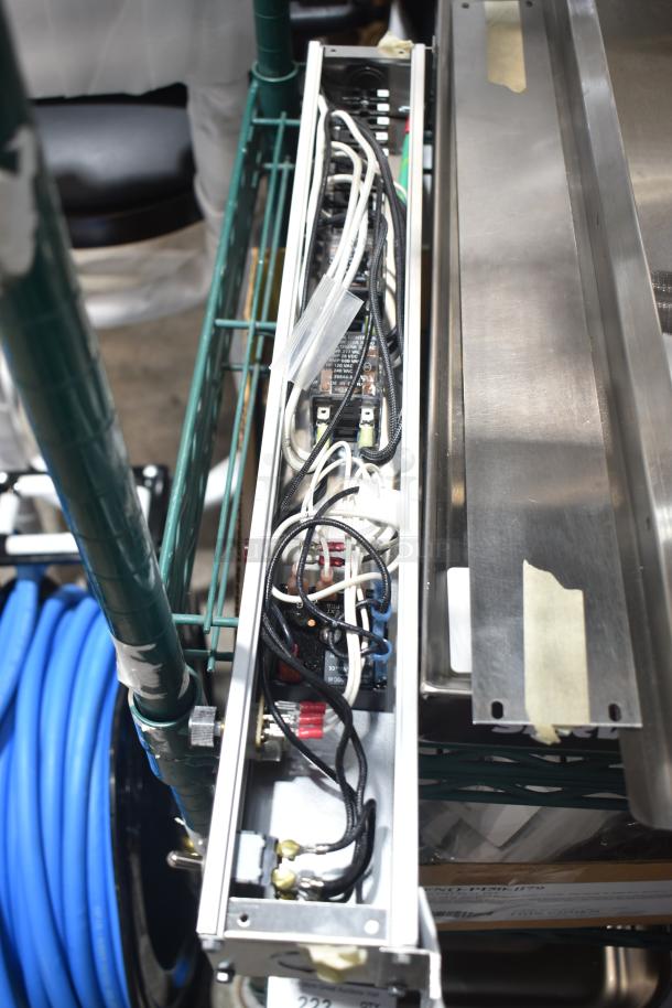 Brand new warming strip with visible wiring, minor scratches, and dents. Metal casing and connected controls visible.