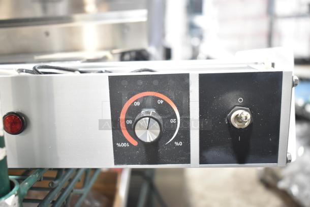 Brand new warming strip with visible scratches and dents. Features a temperature dial, light indicator, and toggle switch.