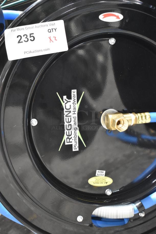 Brand new Regency open powder-coated steel air hose reel with hose, minor cosmetic dents, includes two units, marked with item tag 235.