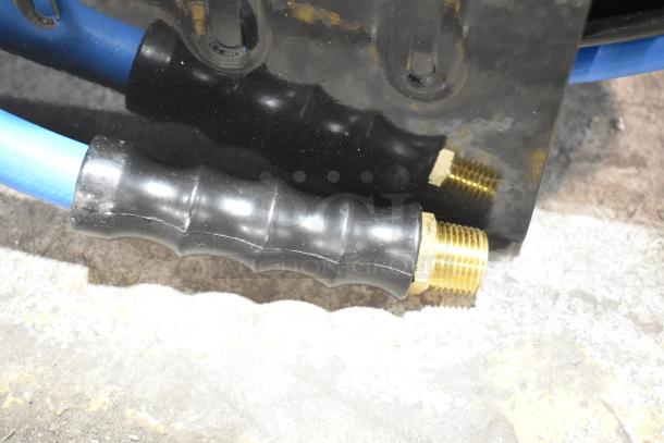 Regency open powder-coated steel air hose reel with attached blue hose; new condition, slight cosmetic scratches.