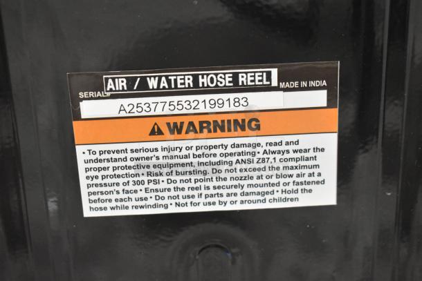Regency open powder-coated steel air hose reel with hose, brand new condition. Visible label: air/water hose reel, serial A253775532199183, made in India, includes warning instructions.