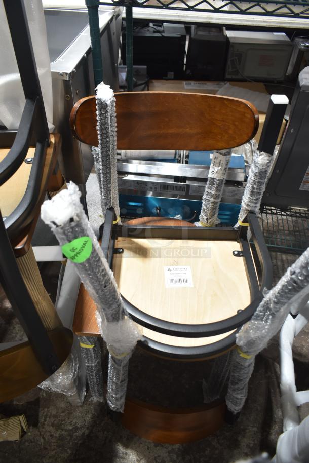 Four brand new scratch and dent chairs, dining height, partially wrapped in protective bubble wrap, showing wood seats and backs.