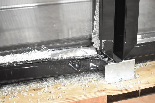 Avantco 178UBB48GTG 48" back bar refrigerator with broken glass door, black finish, LED lighting, and galvanized top.