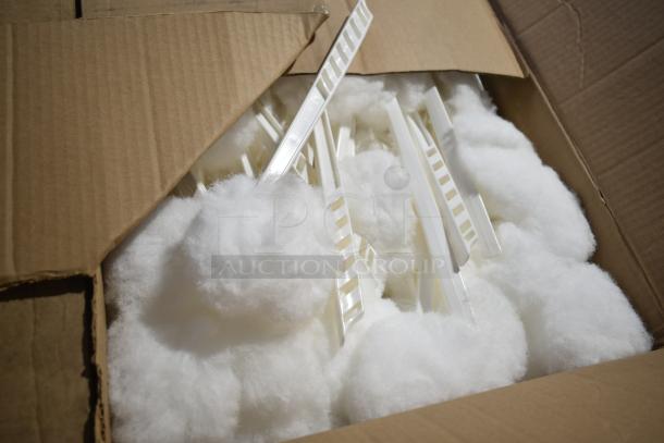 Alt Text: Open box showing white mop toilet bowl brushes with white handles, brand new condition.
