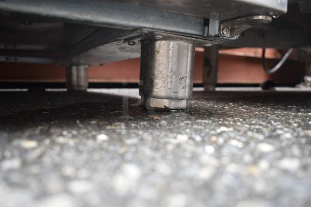 Aspes Commercial 2 Drawer Chef Base, stainless steel leg, 208 volts, sturdy construction, undercarriage view.