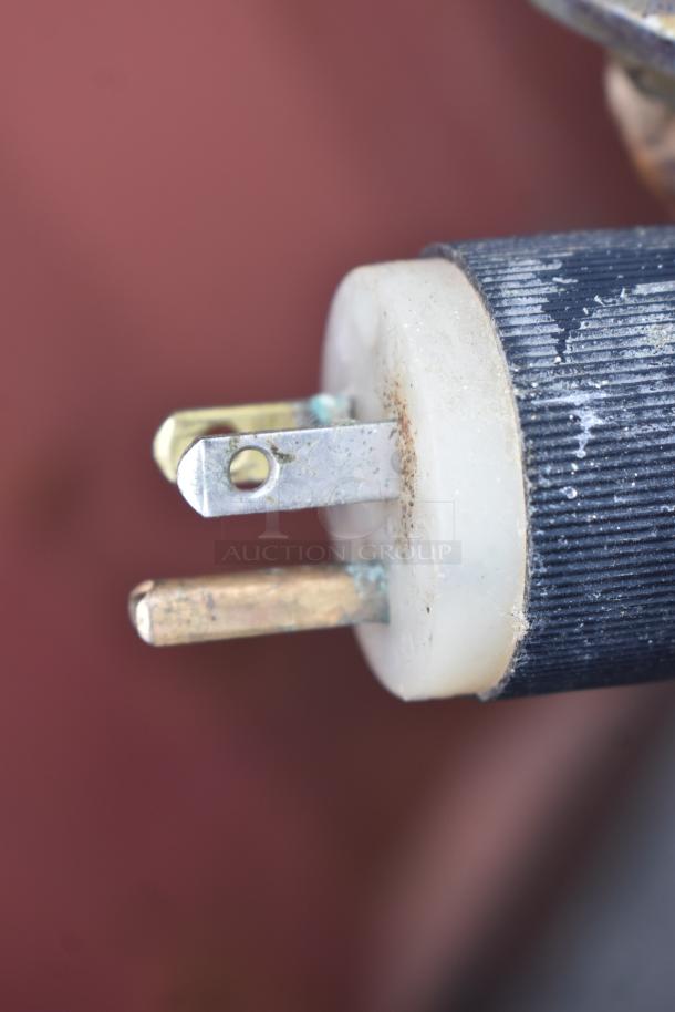 Close-up of a power plug, likely part of a Vulcan-Hart GL40E commercial steam kettle, showing electrical contacts and some wear.