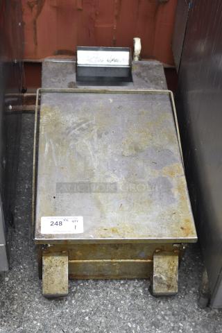 Commercial grease trap with rust and wear, metal construction, auction tag reading "248, QTY 1," for plumbing use.