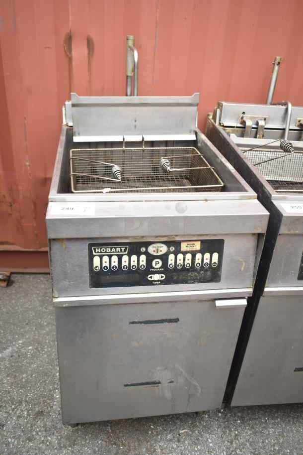 Hobart 1HF85C commercial deep fat fryer, floor style, stainless steel, visible wear, control panel with buttons.