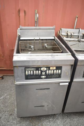 Hobart 1HF85C commercial deep fat fryer, floor style, stainless steel, visible wear, control panel with buttons.