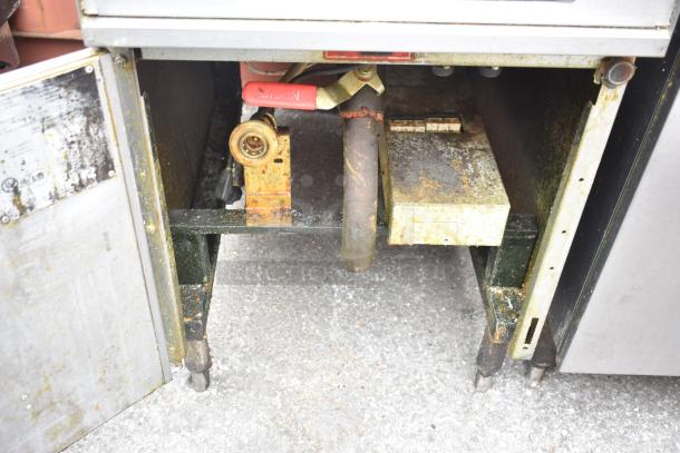 Hobart 1HF85C commercial deep fryer, floor style, visible wear and rust, inspection tags on left door panel.