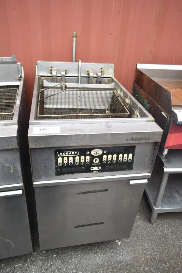 Hobart 1HF85C commercial deep fat fryer, floor style, used condition, with control panel and fryer baskets visible.