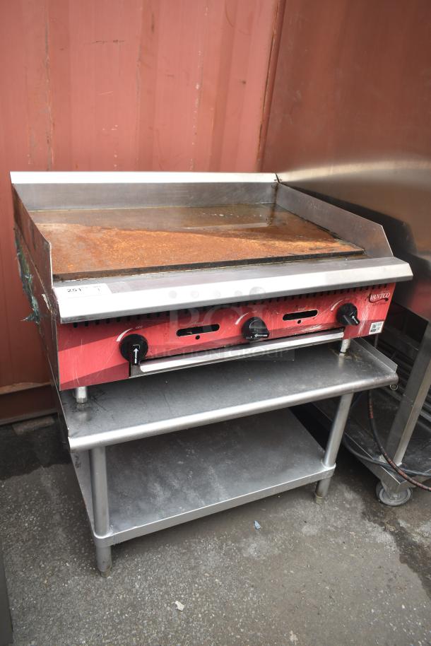 Avantco commercial flat top griddle with controls, on equipment stand; good condition, slight rust on surface.