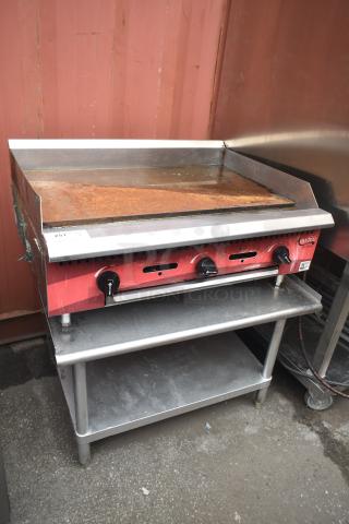 Avantco commercial flat top griddle with controls, on equipment stand; good condition, slight rust on surface.