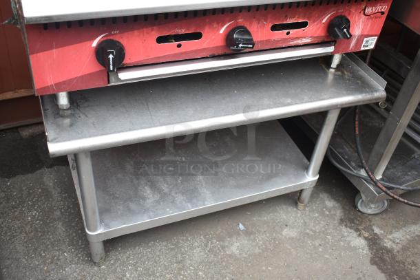 Avantco Commercial Flat Top Griddle on Equipment Stand, featuring control knobs and a sturdy stainless steel build.