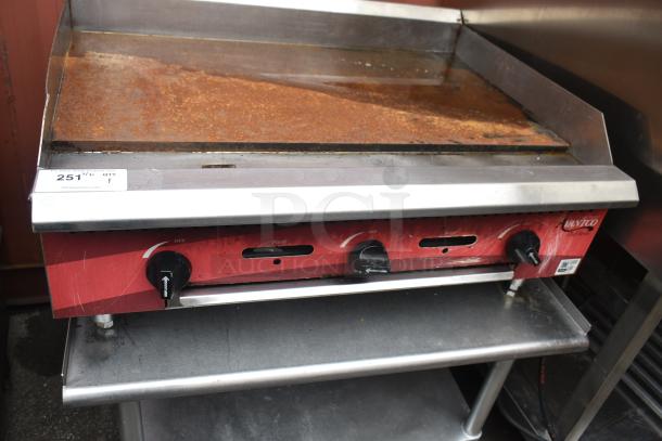 Avantco commercial flat top griddle on equipment stand, visible rust on surface, three control knobs, ID tag number 251.
