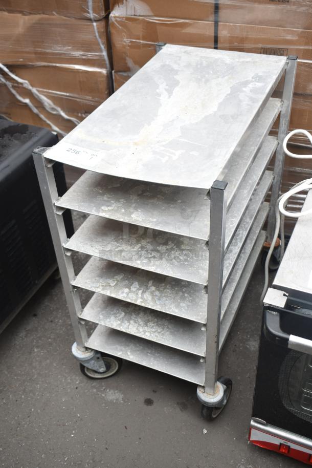 Commercial metal pan rack with six shelves on sturdy casters. Displays wear. Marked with number "256".