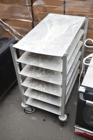 Commercial metal pan rack with six shelves on sturdy casters. Displays wear. Marked with number "256".