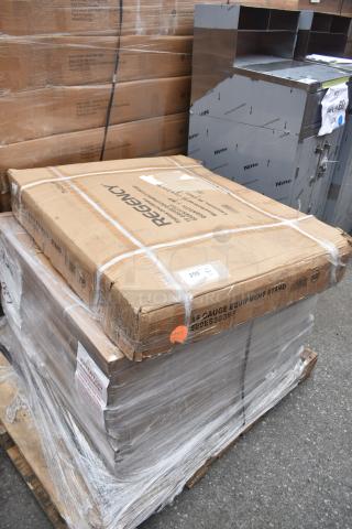 Boxes of equipment, including a Regency equipment stand, wrapped and stacked on a pallet. Some boxes are dented.