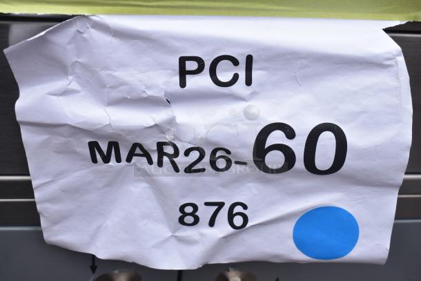 Crumpled paper tag on Lavex mobile desk, reads "PCI MAR26-60 876" with a blue dot. Desk is scratch and dent condition, new.