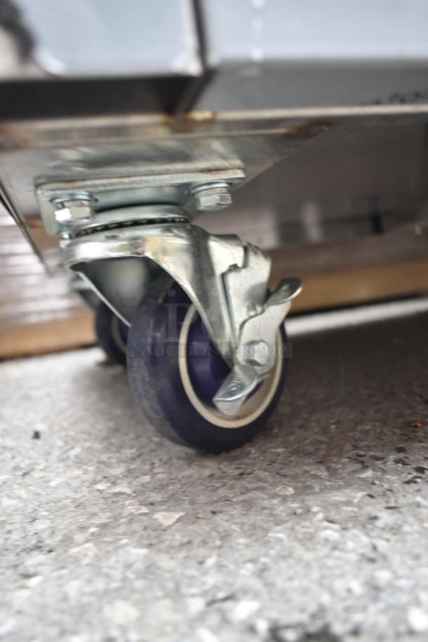 Mobile desk caster wheel of Lavex 257RD2523EBC with braking mechanism, in new condition showing minimal scratches.