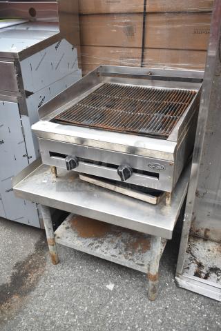 DCS Commercial Countertop Gas Charbroiler Grill on stand, two knobs, used condition, rust on legs, DCS logo visible.