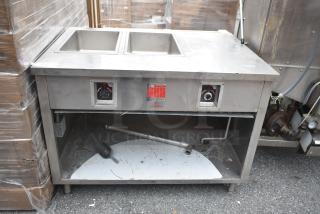 Commercial 2 Well Steam Table with Under Shelf, stainless steel, visible control dials, moderate wear, suited for food service.