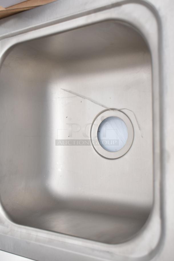 Wall-mounted Regency 600HS12 hand sink, 12" x 16", stainless steel, with scratch, includes gooseneck faucet, brand new.