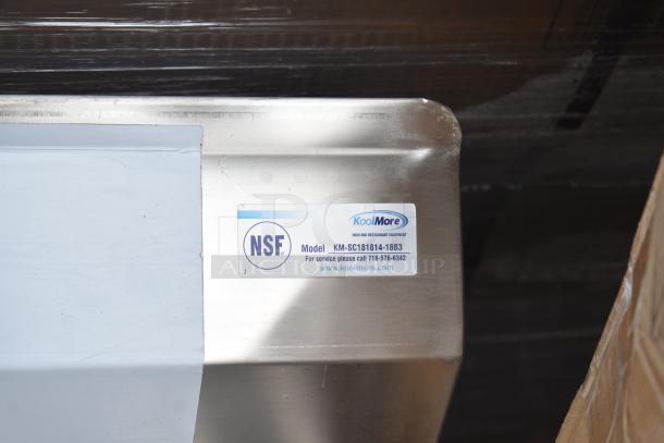 BRAND NEW KoolMore KM-SC181814-1883 stainless steel 3-bay sink with dual drain boards, no legs, NSF label visible.