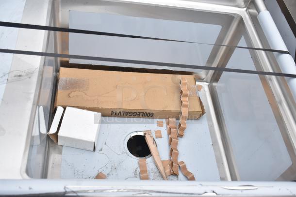 "Brand new Regency 600S1242424L sink, single bay with left drain board, minor scratches, sturdy stainless steel construction."