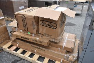 9 brand new scratch and dent items on pallet, including Sterilite latching boxes and shelves, visible labels and minor box damage.
