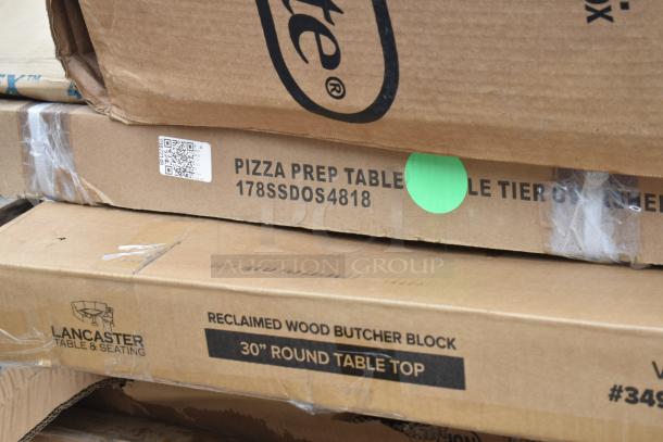 New scratch and dent lot including pizza prep table, Lancaster table top, and more. Labels show models, still boxed.