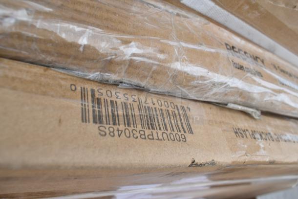 Stacked cardboard boxes with visible barcode and partially wrapped in plastic, indicating shipping or storage of multiple items.