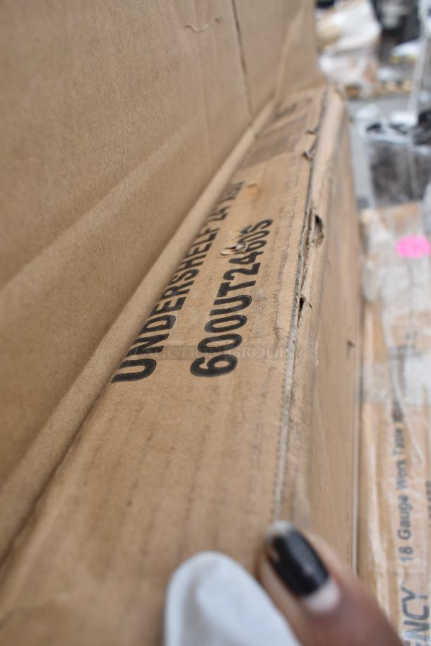 Cardboard box labeled "UNDERSHELF 600UT2460S," part of a lot including a shelf, work table, and more. New condition.