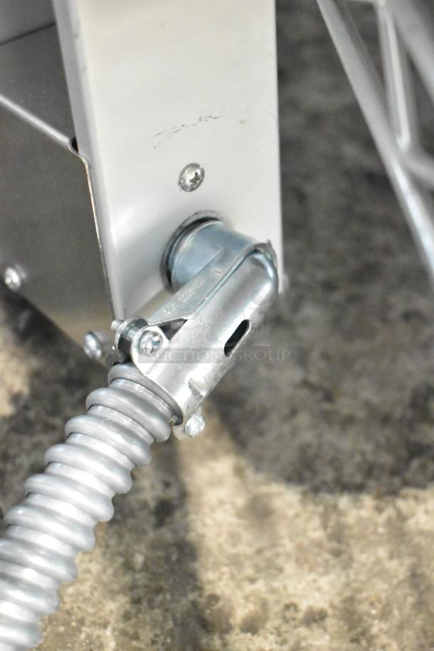 Close-up of ServIt 423SW72TLHA strip warmer component, showing metal connection and coiled conduit. New with minor scratches.