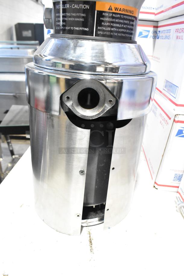 Insinkerator SS100-47 commercial garbage disposer, 1 hp, minor scratch, new, 208/230/460V, 3-phase. Warning label visible.