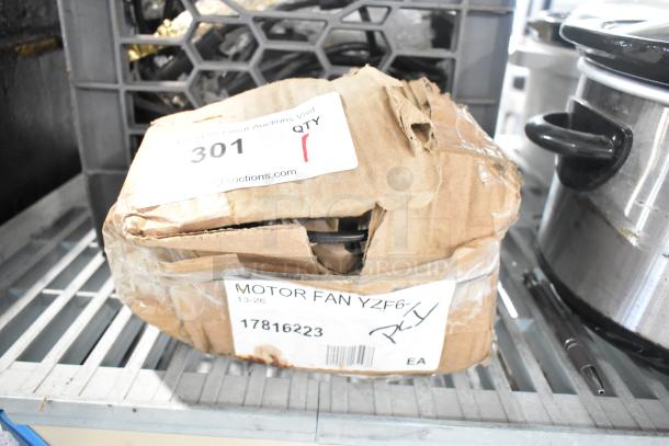 Brand new Avantco 17816223 fan motor, 120V, 33W, in damaged box. Box marked "MOTOR FAN YZF6-", with auction label "301".