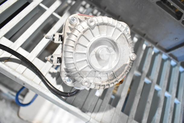 BRAND NEW Avantco 17816223 fan motor, 120V, 33W, visible scratches and dents, mounted on a metal grate.