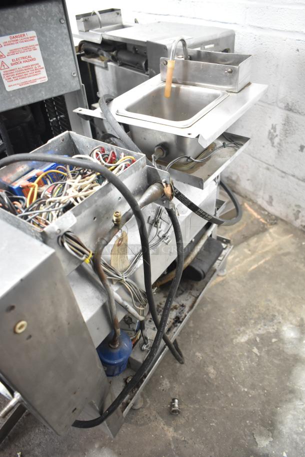 Taylor commercial countertop frozen beverage machine, single flavor, 115 volts, 1 phase; exposed wiring and metal components visible.