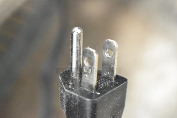 Close-up of the plug from the Chefman RJ50-SST2-P air fryer toaster oven combo showing prongs. Item is brand new, 115 volts.
