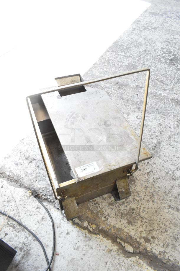 Commercial grease trap with metal construction, showing moderate wear. Tag labeled "248" for identification.