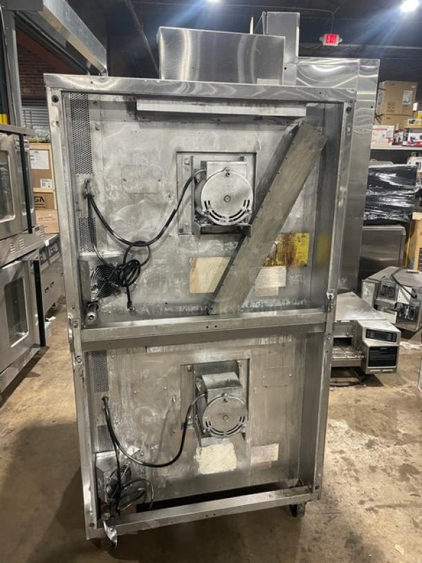 Blodgett commercial gas convection oven, double stacked, stainless steel, wired oven rack, on casters, back view.