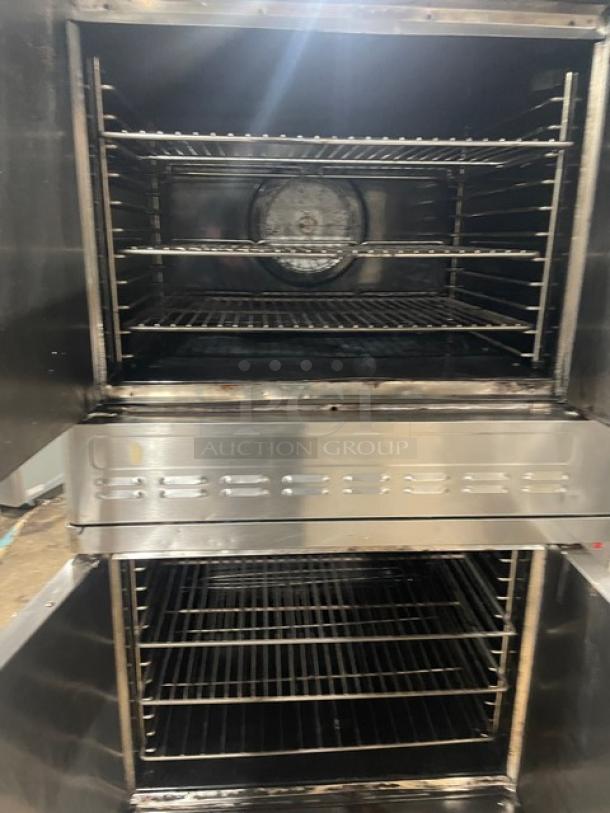Blodgett commercial stainless steel gas-powered double stacked convection oven with wired rack on casters, visible interior.
