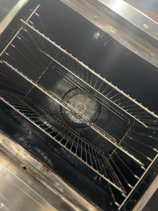 Blodgett commercial stainless steel gas convection oven, double stacked, with wired oven rack, on casters, interior view.