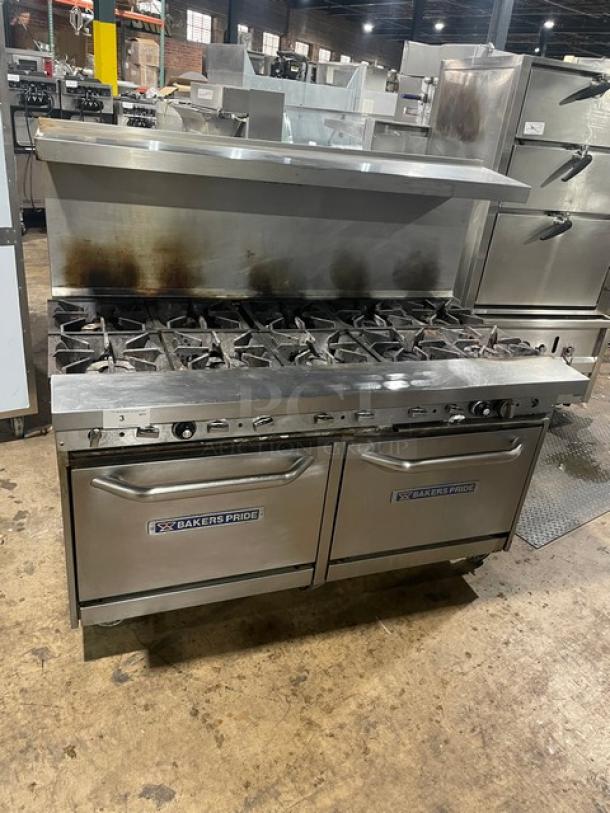 Bakers Pride gas-powered range with 10 burners, double oven, backsplash, overhead salamander shelf, and wired oven rack.